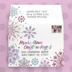 a close up of an envelope with snowflakes on it and a stamp that says mary ann