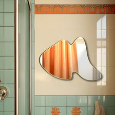 the reflection of a fish in a mirror on a tiled wall next to a shower