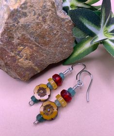 Golden yellow hibiscus flower beads, berry red facet cut beads, golden agate spacers, and Roman glass heishi beads make these very colorful earrings. Striking and eye catching, a great pair for any occasion. Beaded Flower Earrings With Czech Glass For Gifts, Gift Flower Earrings With Beaded Czech Glass, Red Flower Earrings With Colorful Beads As Gift, Gift Beaded Flower Earrings With Czech Glass, Beaded Czech Glass Flower Earrings Gift, Red Flower Beaded Earrings With Dangling Beads, Beaded Flower Earrings In Czech Glass, Yellow Flower Earrings With Colorful Beads, Red Bohemian Jewelry With Flower Charm