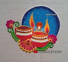 this is an image of diwali rangolim with candles in the middle