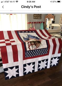 a red white and blue table cloth with an american flag design on it, sitting on top of a hard wood floor