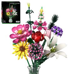 a vase filled with lots of colorful flowers on top of a white table next to a card