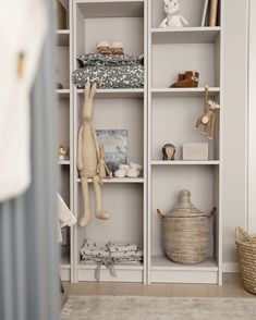 a white bookcase filled with stuffed animals and toys