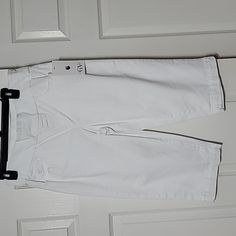 a pair of white pants hanging on a door