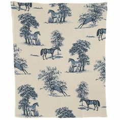 a blue and white blanket with horses in the woods on it's back side