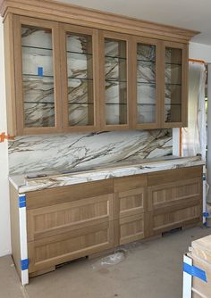 a kitchen with marble counter tops and cabinets in the process of being remodeled by hand