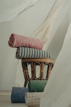 a stack of blankets sitting on top of a chair