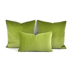 two lime green pillows sitting next to each other