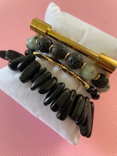 Gemstone Significance: Black Obsidian: Known for its grounding and protective properties, black obsidian helps to shield against negativity and promote emotional balance. Dalmatian Jasper: This unique stone is believed to bring a sense of playfulness and joy, encouraging a positive outlook and a sense of harmony. Versatile Style: The Obsidian & Jasper Bracelet Set is perfect for adding a touch of elegance and sophistication to any outfit. Whether you're dressing up for a special event, adding flair to your everyday look, or seeking a meaningful gift, these bracelets are a versatile and stylish choice. Description: Enhance your jewelry collection with the Obsidian & Jasper Bracelet Set. Handcrafted by skilled artisans, this set features four stunning bracelets made with black obsidian and d Black Spiritual Jewelry With Natural Stones, Modern Black Hematite Jewelry, Minimalist Black Bracelet For Meditation, Minimalist Black Bracelets For Meditation, Black Natural Stones Jewelry For Meditation, Black Onyx Jewelry For Meditation, Elegant Obsidian Bracelets For Meditation, Black Hematite Jewelry For Meditation, Modern Onyx Bracelets For Gift