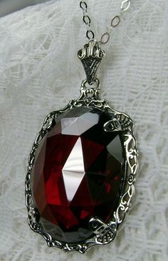 "Red Garnet Cubic Zirconia Pendant Bubble Design#P10 Custom Made Inspired by Victorian era designs, I now offer this lovely Antique reproduction in sterling silver. The flawless 22ct faceted Red Garnet Cubic Zirconia (CZ) is 24mm long (15/16th\") and 18mm in width (3/4th\"). The entire pendant is 1 1/2th inches long and 7/8\" wide. The chain (if chosen) is between 18-20 inches in length and is marked 925 as well. Notice the beautiful craftsmanship of the Victorian filigree setting. This pendant Red Gothic Necklace For Formal Occasions, Red Victorian Necklace For Anniversary, Gothic Crystal Jewelry For Gift, Red Filigree Jewelry For Formal Occasions, Formal Red Filigree Jewelry, Red Ruby Victorian Necklace, Red Pendant Jewelry For Formal Occasions, Gothic Jewelry For Valentine's Day Formal, Red Crystal Pendant Jewelry