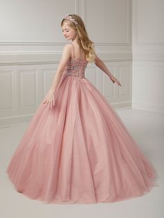 Your sweet girl will make a grand entrance in this bead embroidered long sleeveless illusion dress with A-line tulle skirt by Tiffany Princess 13723. This sleeveless gown features an illusion scoop neck sweetheart bodice with floral beaded embellishments, A-line sparkle tulle skirt, sweep train, and a lace-up back. House of Wu Tiffany Princess Collection Fall 2023 Style Number: 13723 Fabric: Floral Beading/Sparkle Tulle Please note: There may be a loss of glitter while wearing this dress due to