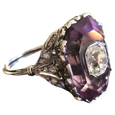 Exquisite in every way, this French Belle Epoque ring centers on 1.03 carat old mine cut diamond, bezel set and seated within an octagonal step cut amethyst. The mounting is like a tiny crown, delicately detailed with lacy openwork and twinkling rose cut diamond details. This beauty sparkles from every angle. Currently a size 5.25. Weight: 8 grams Markings: French dog's head assay mark Measurements: 18.8 x 13.3 mm, sits 11 mm off of the finger Diamonds: estimated 1.03 carat old mine cut, SI2 cla Art Deco Octagon Ring With Rose Cut Diamonds, Art Deco Octagon Rings With Rose Cut Diamonds, Art Deco Octagon Rose Cut Diamond Rings, Formal Amethyst Ring With Rose Cut Diamonds, Vintage Purple Diamond Ring, Formal Amethyst Rings With Rose Cut Diamonds, Purple Diamond Ring With Rose Cut Diamonds, Purple Rose Cut Diamond Ring, Rose Cut Diamond Ring