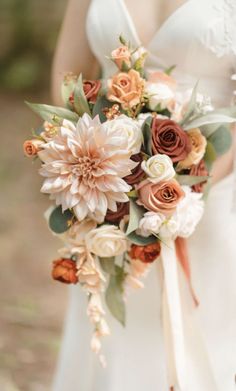 a bride holding a bouquet of flowers in her hand