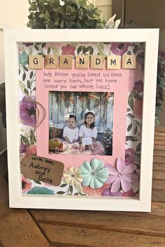 a photo frame with the words grandma spelled in scrabbles and flowers on it