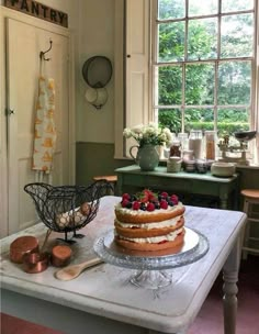 a cake sitting on top of a table next to a window