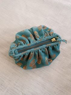 a teal colored purse sitting on top of a white table