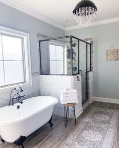 a white bath tub sitting in a bathroom next to a window