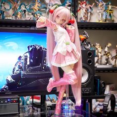 a doll is posed in front of a television