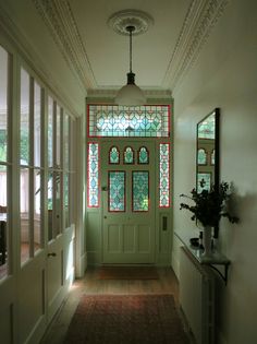 a green door with stained glass on the windows