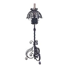 an ornate black metal candle holder on a white background