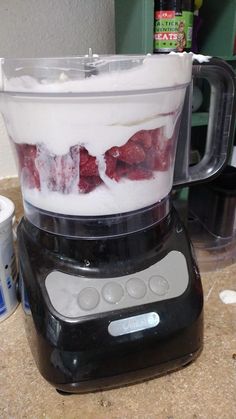 a blender filled with liquid sitting on top of a counter