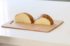 two pieces of bread sitting on top of a cutting board