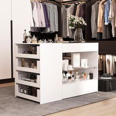 an organized closet with clothes and accessories on display in front of the door to another room