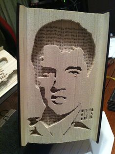 an altered portrait of a man's face on a piece of wood with words written in it