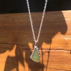 This genuine green sea glass necklace is the perfect way to accessorize any outfit, and makes a great gift! Made from one piece of GENUINE green sea glass tumbled naturally by the ocean, and soldered to complete the look Every purchase will INCLUDE an 18" necklace chain as seen in the photos.  Perfect way to carry a little piece of the ocean with you wherever you go!   Ships FREE to the US with purchase of $35 or more from our shop! Please note that these necklaces are individually handmade, and Recycled Glass Green Jewelry For Beach, Green Recycled Glass Jewelry For The Beach, Green Recycled Glass Beach Jewelry, Handmade Green Sea Glass Necklace, Silver Sea Glass Necklace With Wire Wrapped Detail, Light Sun, Beach Glass Necklace, Ocean-inspired Sea Glass Necklaces For Beach, Adjustable Ocean-inspired Sea Glass Jewelry