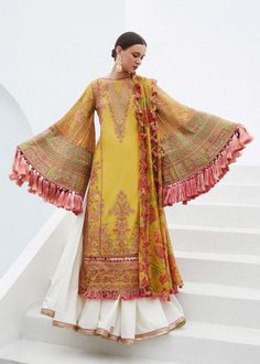 Colour: Pale Yellow Product Description: This pastel yellow summery resplendant shirt with complex floral embroideries merging with geometeric details creating a phenomenal vibe. Interesting contrast of green in borders adds a glimpse of freshness to the floral arrangement in the heavily embroidered sleeve making it a statement for this summer season. Adding the printed chiffon dupatta with floral print taking its inspiration from chintz pattern, finished with pretty scalloped four sided borders Hussain Rehar, Salwar Dress, Gaun Fashion, Dress Salwar Kameez, Winter Shawl, Lawn Suits, Pakistani Designers, Shalwar Kameez