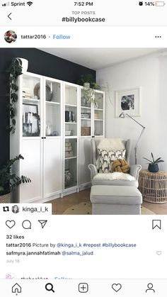 a room with white furniture and lots of plants on the shelves in front of it