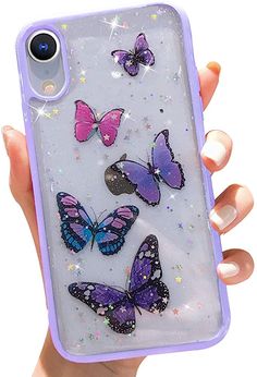 a hand holding a purple phone case with butterflies on the front and back, while it's covered in sequins