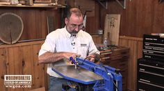 a man working on a piece of metal in his workshop with tools and woodworking equipment