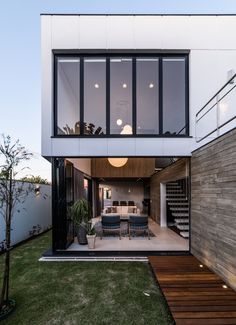 a modern house with an outdoor dining area