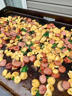 there are many different types of food on the grill, including sausages and spinach