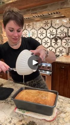 a woman pouring batter into a pan on top of a counter