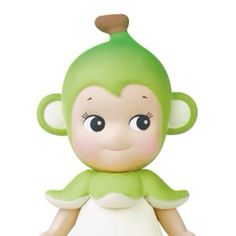 a small toy monkey with green hair and big eyes