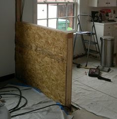 an unfinished room with some tools on the floor next to it and a window in the wall