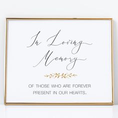 a white and gold framed sign with the words in loving memory