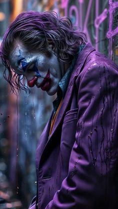 a man dressed as the joker is looking down