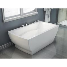 a white bath tub sitting next to a window