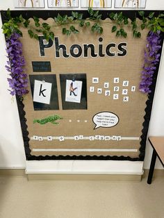 a bulletin board is decorated with purple flowers and green leaves, along with the words phonics on it