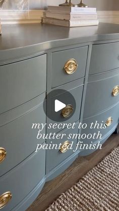 a grey dresser with gold handles and knobs