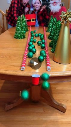 a group of people standing around a table with christmas decorations