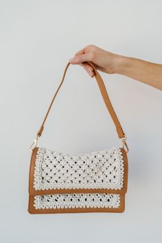 Elevate your boho-chic style with our stunning Gianna Macrame clutch handbag. The intricate ivory macrame design intricately woven onto the brown leather bag creates a captivating contrast. With a short carry strap for easy portability and a flap-over style for extra security, this handbag effortlessly combines fashion and function. Make a statement with this unique accessory that adds a touch of bohemian elegance to any ensemble. Brown Braided Crochet Shoulder Bag, Cream Crochet Crossbody Bag With Braided Handles, Beige Woven Leather Clutch Shoulder Bag, Beige Macrame Shoulder Bag, Chic Rectangular Macrame Bag, Chic Macrame Rectangular Shoulder Bag, Chic Rectangular Macrame Shoulder Bag, Bohemian Woven Leather Crochet Shoulder Bag, Cream Crochet Clutch Bag For Everyday Use