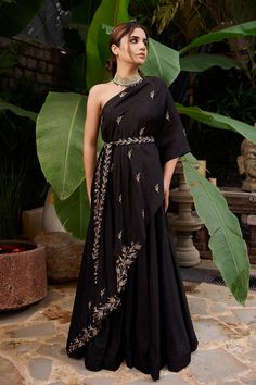 Black one shoulder asymmetric kurta with floral embroidered motifs. Paired with skirt and belt.
Components: 3
Fabric: Raw Silk, Shantoon
Neckline: Asymmetric
Sleeve Length: Asymmetric
Color: Black
Embroideed 
Floral motif work
Embroidered belt
One shoulder kurta - Aza Fashions Prathyusha Garimella, Purple Anarkali, One Shoulder Cape, Trendy Outfits Indian, Indian Outfits Lehenga, Shoulder Cape, Indo Western Dress, Indian Dresses Traditional, Traditional Indian Outfits