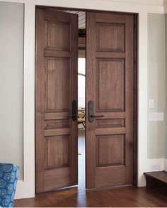 two wooden doors are open in the living room