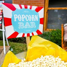 a popcorn bar sign sitting on top of a table