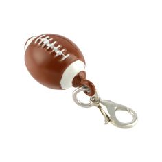 a brown and white football keychain with a pair of scissors hanging from it