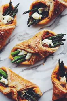 asparagus, goat cheese and spinach pastries on a marble countertop